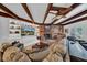 Living area features exposed beams, a fireplace, and comfortable seating at 4307 W Kensington Ave, Tampa, FL 33629