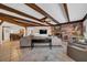 Living room with exposed beams, fireplace, and built-in shelving at 4307 W Kensington Ave, Tampa, FL 33629