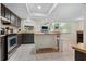 Kitchen with dark wood cabinets, stainless steel appliances, and an island at 4606 Ridgecliff Dr, Brandon, FL 33511