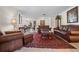 Spacious living room featuring brown leather furniture and a red rug at 4606 Ridgecliff Dr, Brandon, FL 33511
