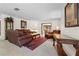 Living room with brown leather sofas, a coffee table, and an ornate rug at 4606 Ridgecliff Dr, Brandon, FL 33511