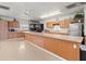 Well-equipped kitchen featuring ample cabinetry and stainless steel appliances at 4822 Sedeno Dr, Zephyrhills, FL 33541