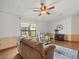 Living room with hardwood floors, comfy seating, and plenty of natural light at 4822 Sedeno Dr, Zephyrhills, FL 33541