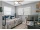 Bright bedroom with a bed, desk, and window coverings at 496 Oakwood Dr, Dunedin, FL 34698