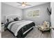 Main bedroom with a king-size bed and accent chair at 496 Oakwood Dr, Dunedin, FL 34698