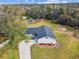 Aerial view of a ranch-style house with a large backyard and surrounding trees at 516 Highview N Cir, Brandon, FL 33510