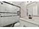 Modern bathroom with white vanity, glass shower, and marble tile at 516 Highview N Cir, Brandon, FL 33510