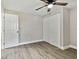 Bedroom with wood-look floors, ceiling fan, and adjacent closet at 516 Highview N Cir, Brandon, FL 33510