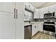 Modern kitchen with white cabinets, stainless steel appliances, and quartz countertops at 516 Highview N Cir, Brandon, FL 33510