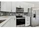 Modern kitchen with white cabinets and stainless steel appliances at 516 Highview N Cir, Brandon, FL 33510