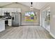 Modern kitchen with white cabinets, stainless steel appliances, and backyard view at 516 Highview N Cir, Brandon, FL 33510