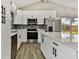 Modern kitchen with white cabinets, stainless steel appliances, and a quartz island at 516 Highview N Cir, Brandon, FL 33510
