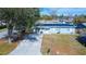 Aerial view of a single-story home with solar panels and a spacious driveway at 5481 65Th N Ave, Pinellas Park, FL 33781