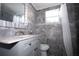 Modern bathroom with gray tile and updated vanity at 5481 65Th N Ave, Pinellas Park, FL 33781