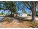 Exterior view of a light blue house with mature trees and a driveway at 5481 65Th N Ave, Pinellas Park, FL 33781