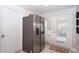 Kitchen with stainless steel refrigerator and French doors leading outside at 5481 65Th N Ave, Pinellas Park, FL 33781