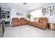 Living room featuring brown leather sofas and a calming decor at 5481 65Th N Ave, Pinellas Park, FL 33781