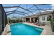 Large screened-in pool with plenty of lounge chairs for relaxation at 5721 Long Shore Loop, Sarasota, FL 34238