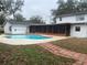 House and kidney shaped pool in backyard at 6919 Greenhill Pl, Tampa, FL 33617