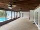 Spacious screened patio with fans and access to the backyard pool area at 6919 Greenhill Pl, Tampa, FL 33617