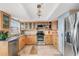 Modern kitchen featuring stainless steel appliances and wood cabinetry at 7 Elgin Pl # 401, Dunedin, FL 34698