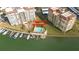 Aerial view of condo complex with pool, clubhouse, and boat slips at 700 Island Way # 504, Clearwater, FL 33767
