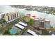 Aerial view of building, emphasizing its waterfront setting and tennis court at 700 Island Way # 504, Clearwater, FL 33767