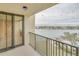 Private balcony with glass doors and metal railing overlooking water at 700 Island Way # 504, Clearwater, FL 33767