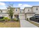 Two-story townhome with attached garage and landscaping at 7014 Summer Holly Pl, Riverview, FL 33578
