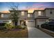 Attractive townhome exterior at dusk; two-story with attached garage at 7014 Summer Holly Pl, Riverview, FL 33578