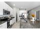 Modern kitchen with island, pantry, and stainless steel appliances at 7014 Summer Holly Pl, Riverview, FL 33578