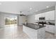 Modern kitchen with island, stainless steel appliances, and breakfast bar at 7014 Summer Holly Pl, Riverview, FL 33578