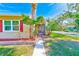 Tan house with red shutters and a walkway leading to the front door at 7701 57Th N St, Pinellas Park, FL 33781