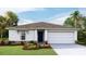 One-story home with a two-car garage and landscaped lawn at 7812 Wheat Stone Dr, Zephyrhills, FL 33540