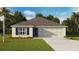 One-story home with two-car garage and landscaped lawn at 7820 Wheat Stone Dr, Zephyrhills, FL 33540