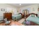 Charming bedroom with twin beds, wood dresser, and hardwood floors at 7312 7Th Nw Ave, Bradenton, FL 34209