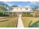Two-story house with a wraparound porch and landscaped yard at 7312 7Th Nw Ave, Bradenton, FL 34209