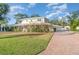 Two-story house with a paver driveway and lush landscaping at 7312 7Th Nw Ave, Bradenton, FL 34209