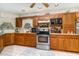 Kitchen features wood cabinets, stainless steel appliances, and tile flooring at 7312 7Th Nw Ave, Bradenton, FL 34209
