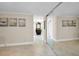 Long hallway with mirror and decorative artwork at 100 Oakmont Ln # 602, Belleair, FL 33756