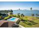 Community pool with water view and lush landscaping at 100 Oakmont Ln # 602, Belleair, FL 33756