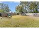 Large grassy backyard with playset and wooden fence at 10228 Oslin St, Tampa, FL 33615