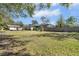 Large backyard with grassy area, shed, playground, and wooden fence at 10228 Oslin St, Tampa, FL 33615