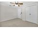 Spacious bedroom with ceiling fan and double doors at 10228 Oslin St, Tampa, FL 33615