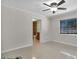 Bedroom with ceiling fan, view of bathroom, and tile floors at 10228 Oslin St, Tampa, FL 33615