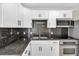 Modern kitchen with white cabinets, granite counters, and stainless steel appliances at 10228 Oslin St, Tampa, FL 33615