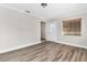 Bright living room with wood-look floors and exterior door at 10228 Oslin St, Tampa, FL 33615