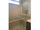 Modern bathroom with a walk-in shower and marble tile at 1046 Bass Blvd, Dunedin, FL 34698