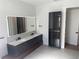 Modern bathroom with double vanity and glass-door cabinet at 1046 Bass Blvd, Dunedin, FL 34698