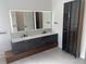 Modern bathroom with double vanity and large mirrors at 1046 Bass Blvd, Dunedin, FL 34698